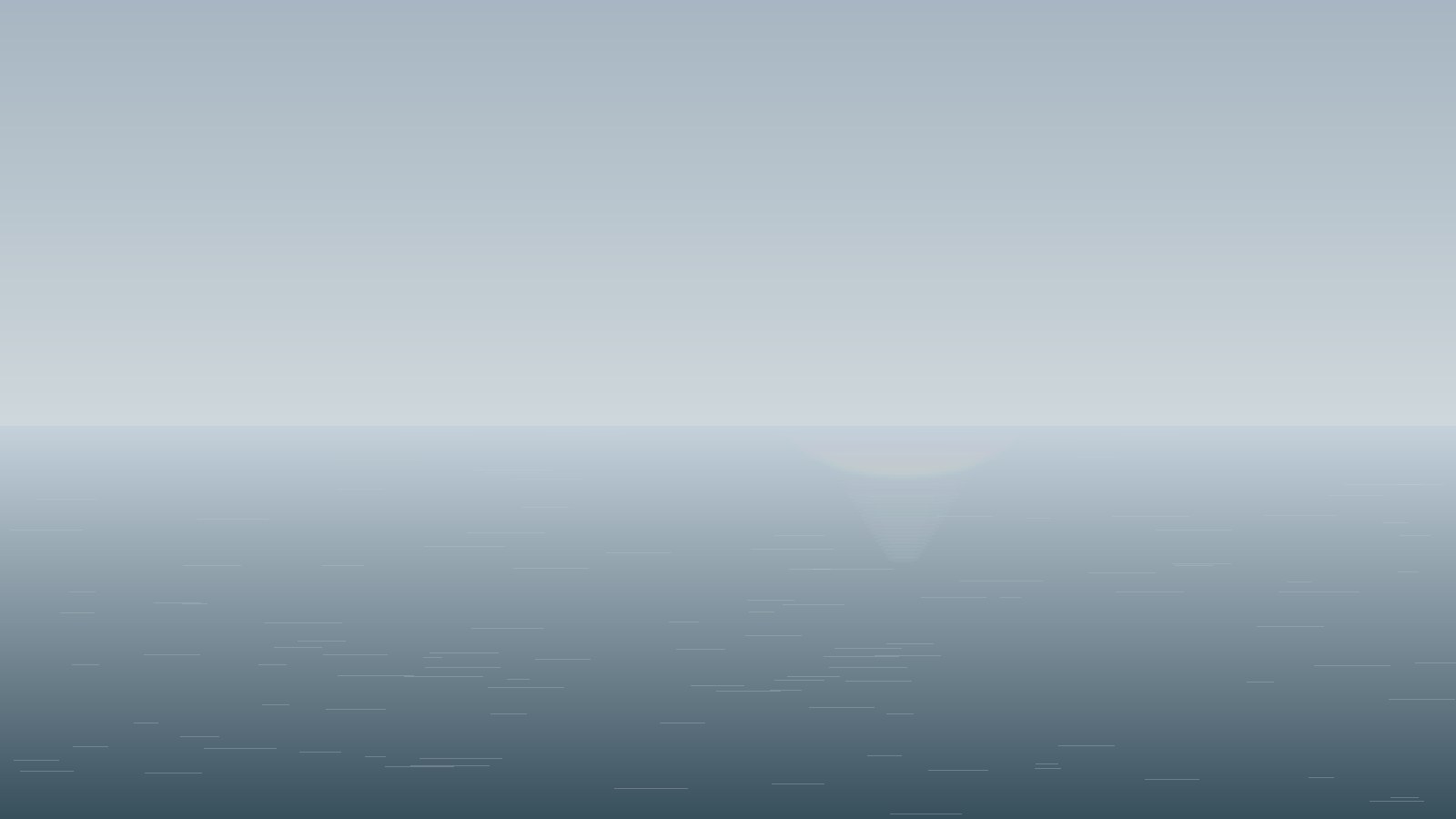 A still, steel-grey lake under a pale sky, the cold water flat and calm, mist low on the far shore.