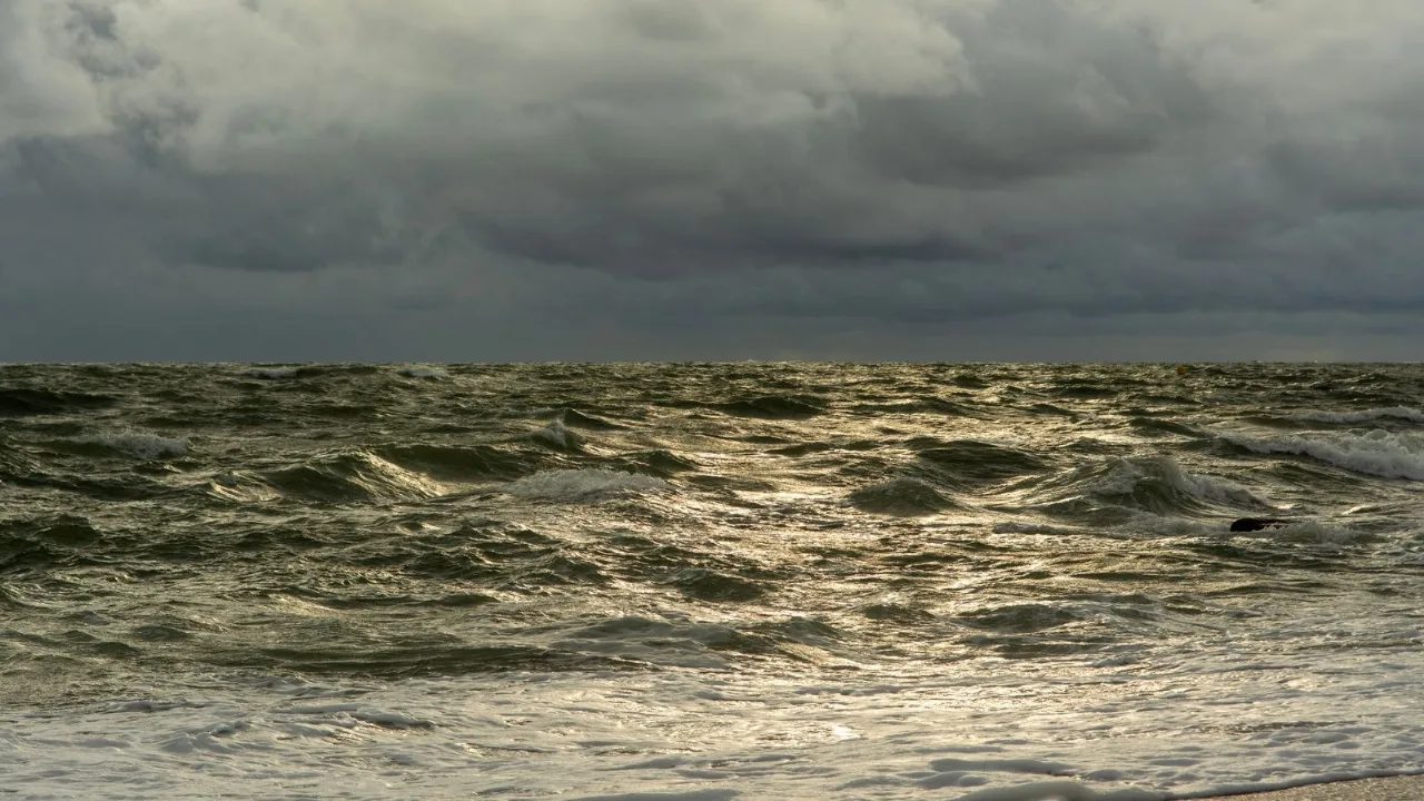 A grey, wind-textured sea running to the horizon under a heavy overcast sky.