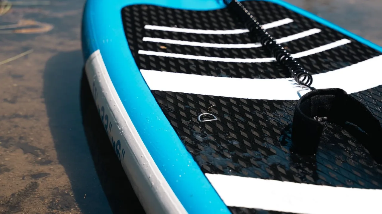 A close view of a paddleboard's deck pad and leash, the gear that wears with every session.